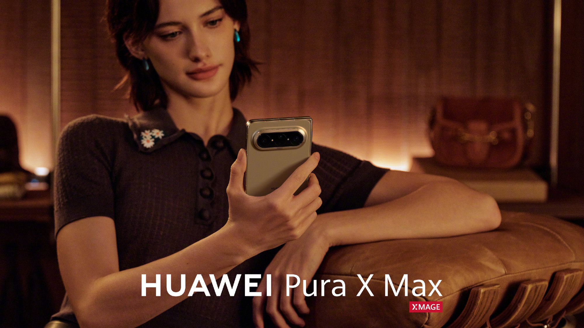 A woman looking at a gold Huawei Pura X Max in hand