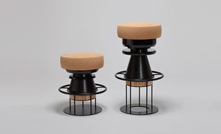 Sculptural stool that combines a wood and metal body with a solid cork seat