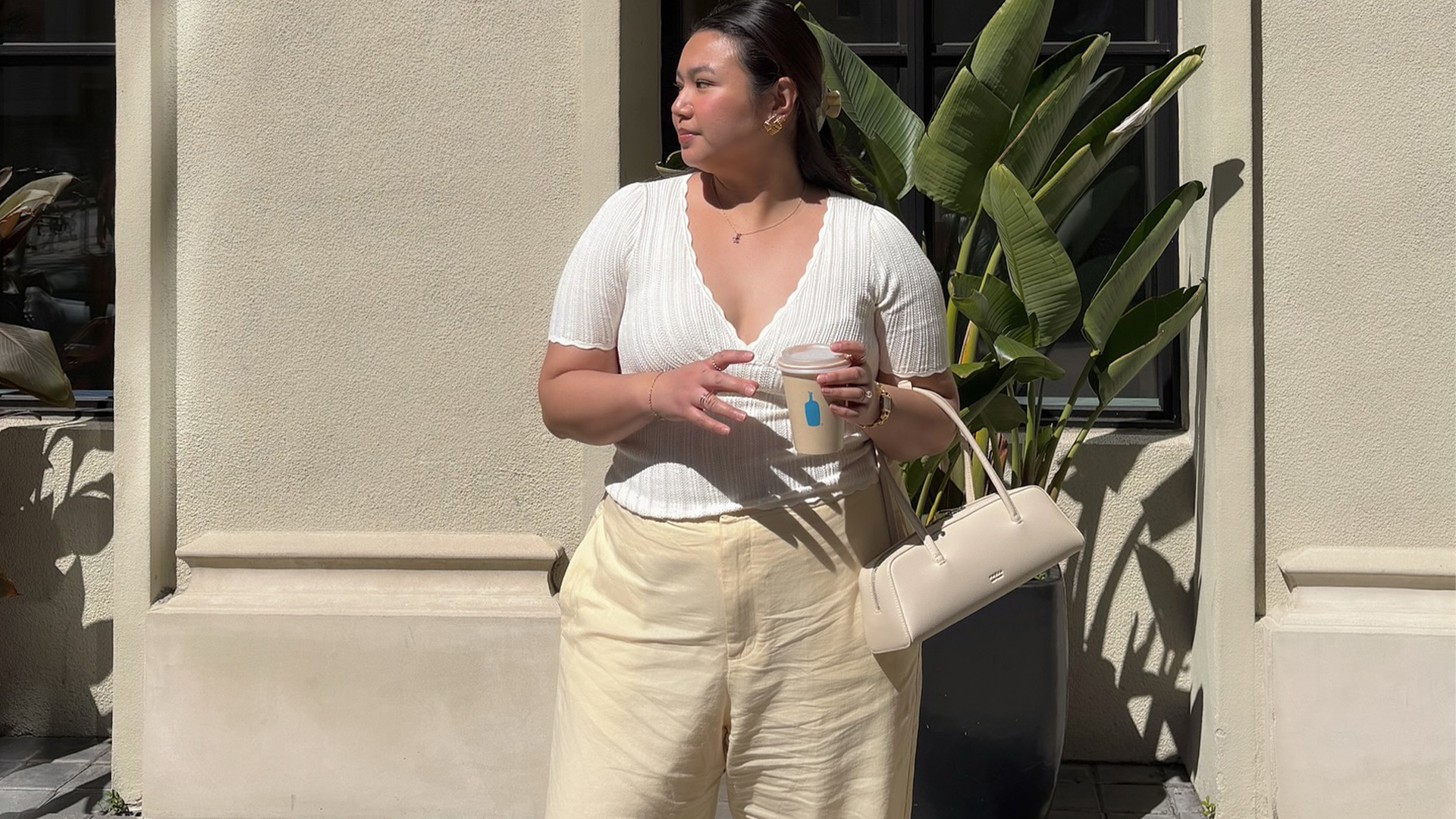 Marina wears white top and cream pants and cream tabi flats and cream freja bag