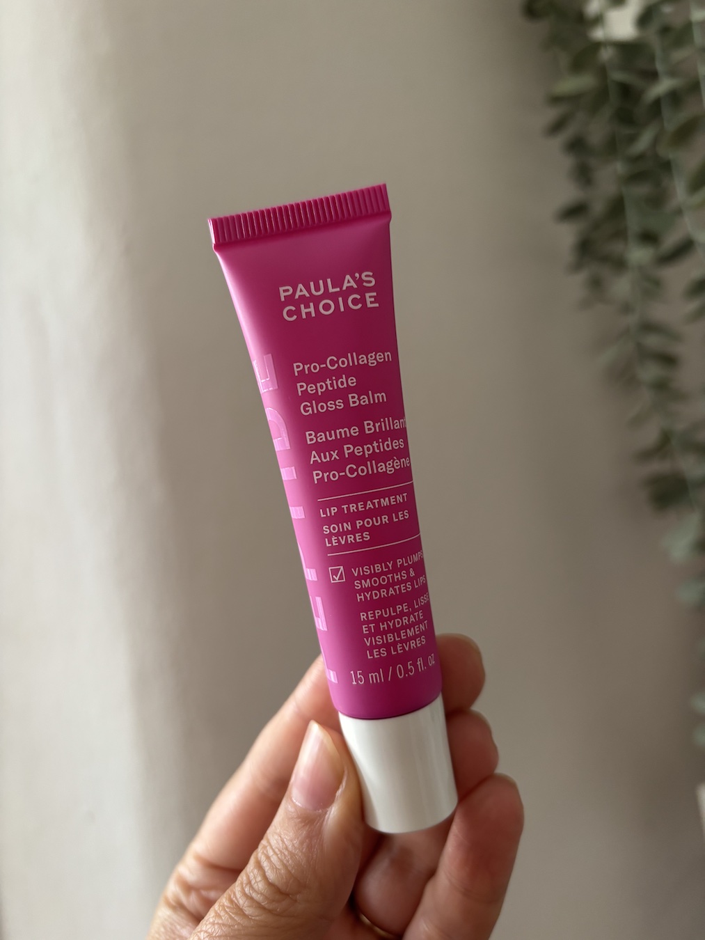 Mica Ricketts holding Paula's Choice Pro-Collagen Peptide Gloss Balm