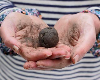 clay soil ball in hands