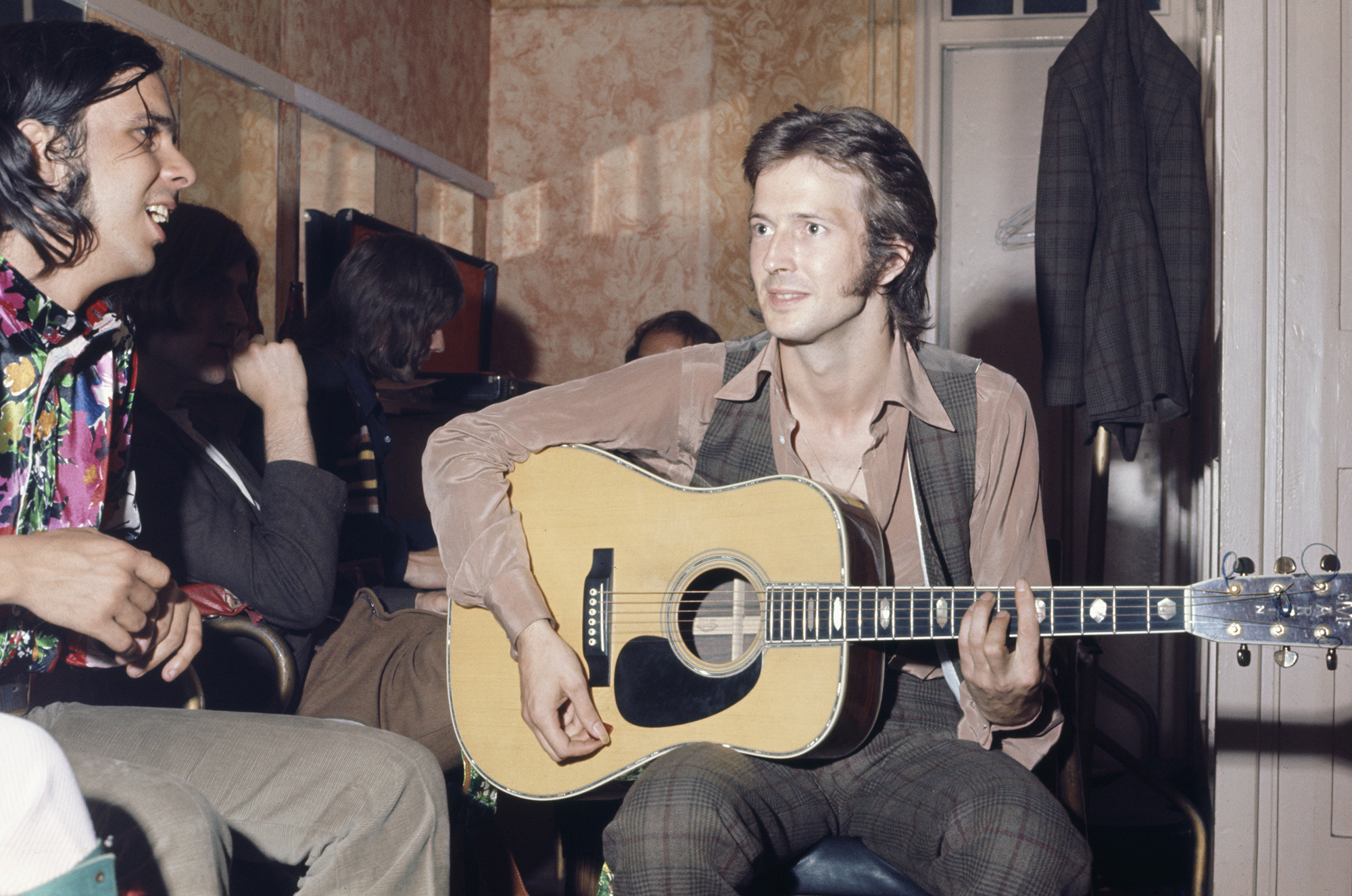 Eric Clapton (right, playing a Martin acoustic guitar) and Bobby Whitlock (left) of Derek and The Dominos, backstage before the band&#039;s live debut at the Lyceum Theatre, London, 14th June 1970.