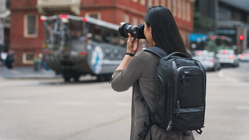 The Think Tank Walker Pro camera backpack worn by a photographer