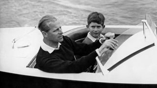 Prince Philip young - Undated picture showing Prince Charles of Wales with his father Prince Philip of Edinburgh on board a boat. (Photo by - / AFP) (Photo by -/AFP via Getty Images)