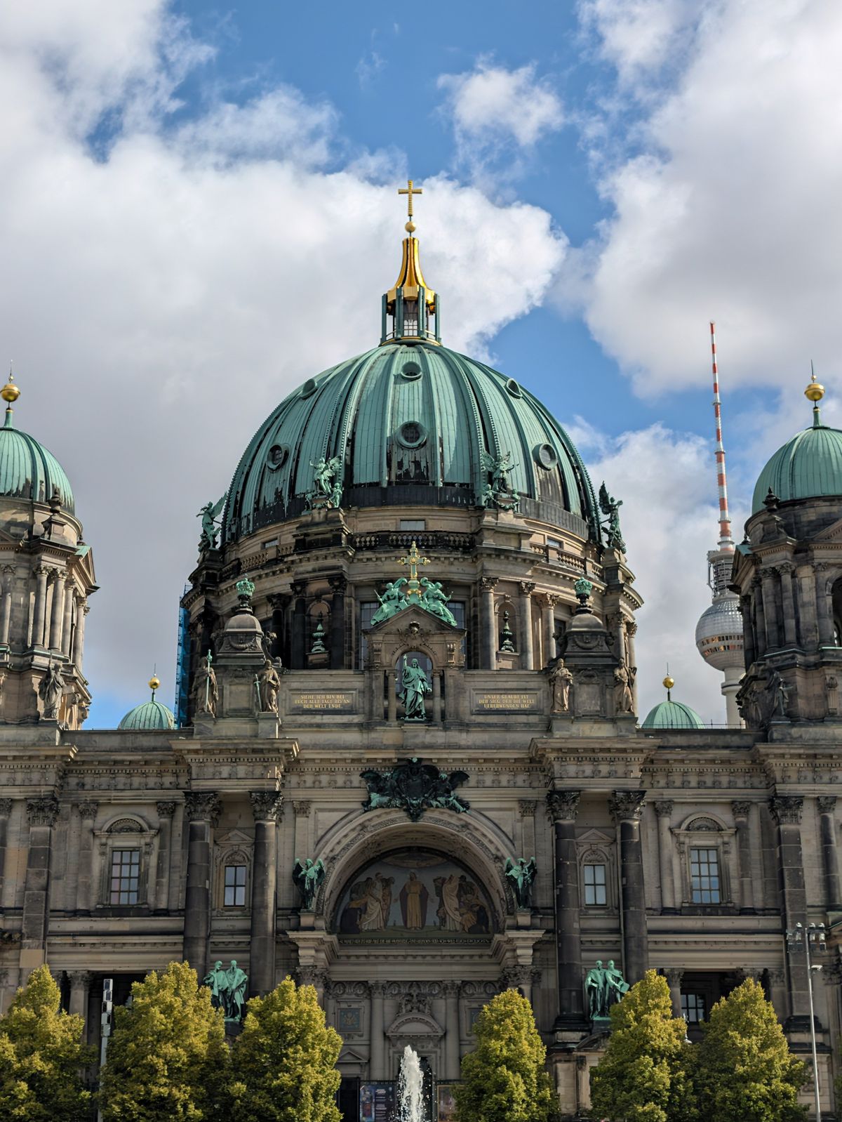 Telephoto view of Berlin Cathedral&rsquo;s central green dome, with the Berlin TV Tower visible behind.