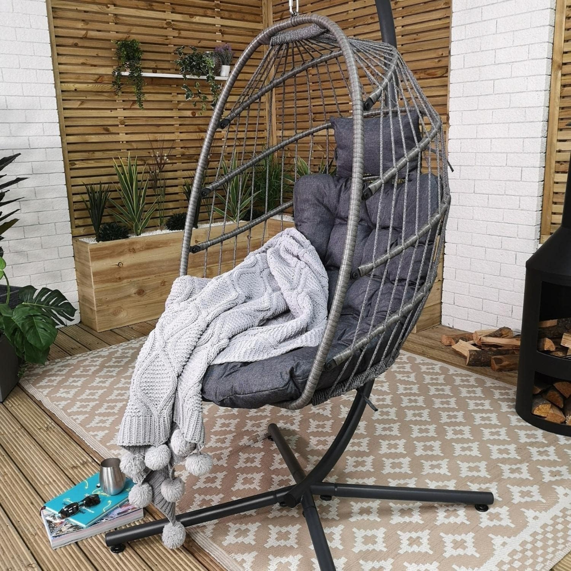 Samuel Alexander Grey Hanging Egg Chair on a patio