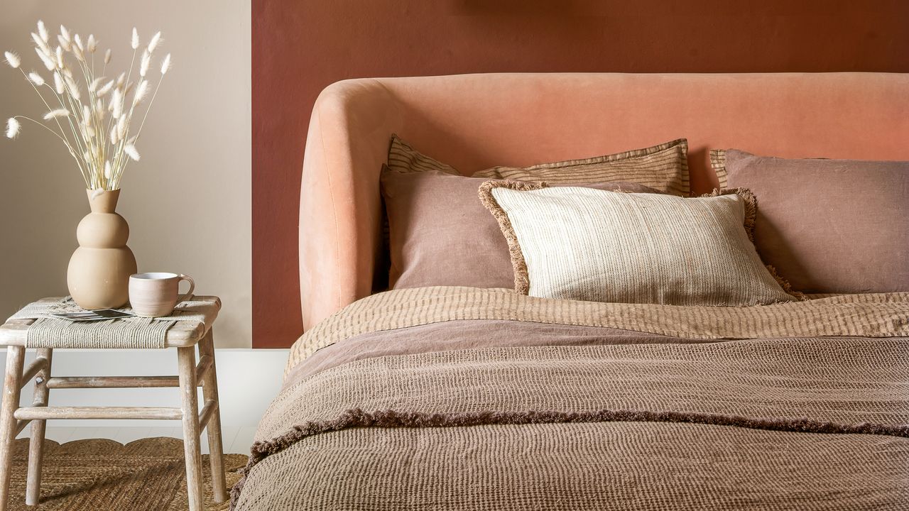 a neutral bedroom in earthy shades with textured bedlinen