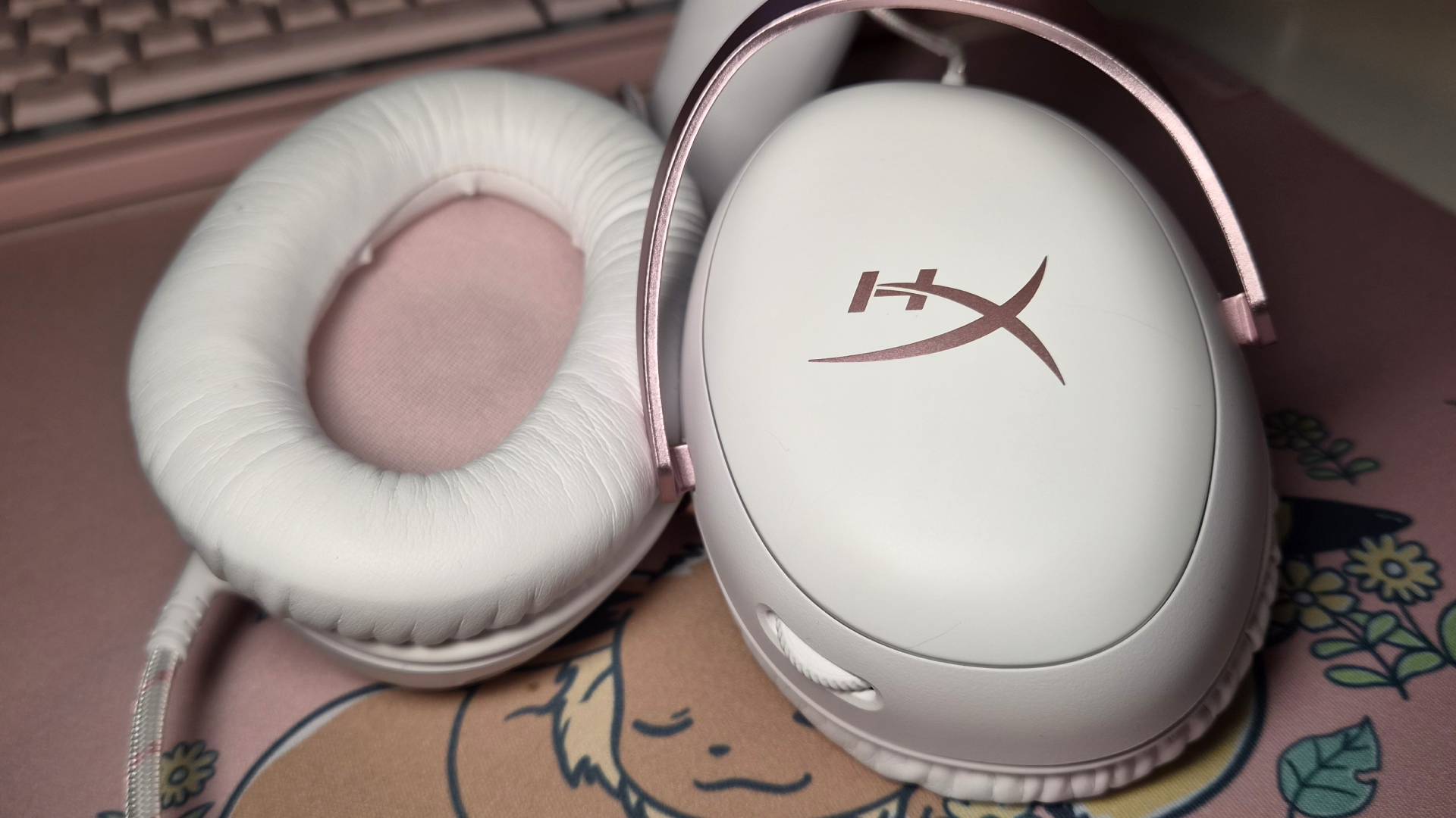 Photo of the earcups of the White-Pink HyperX Cloud III wired gaming headset.