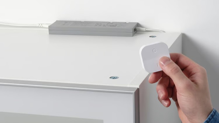 IKEA Tradfri driver with person's hand holding remote control