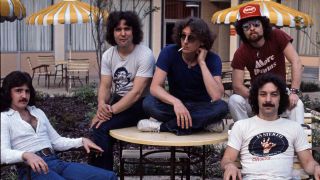 Blue Oyster Cult relaxed next to a swimming pool in 1976