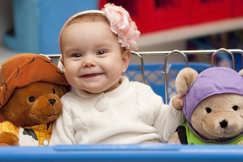 a baby between two teddy bears