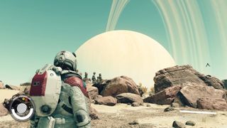 Starfield - En person i en romdrakt ser på en ringplanet