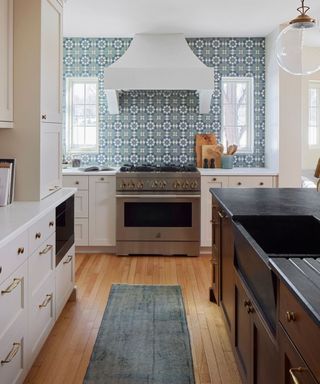 Kitchen with light blue tiles above the hob