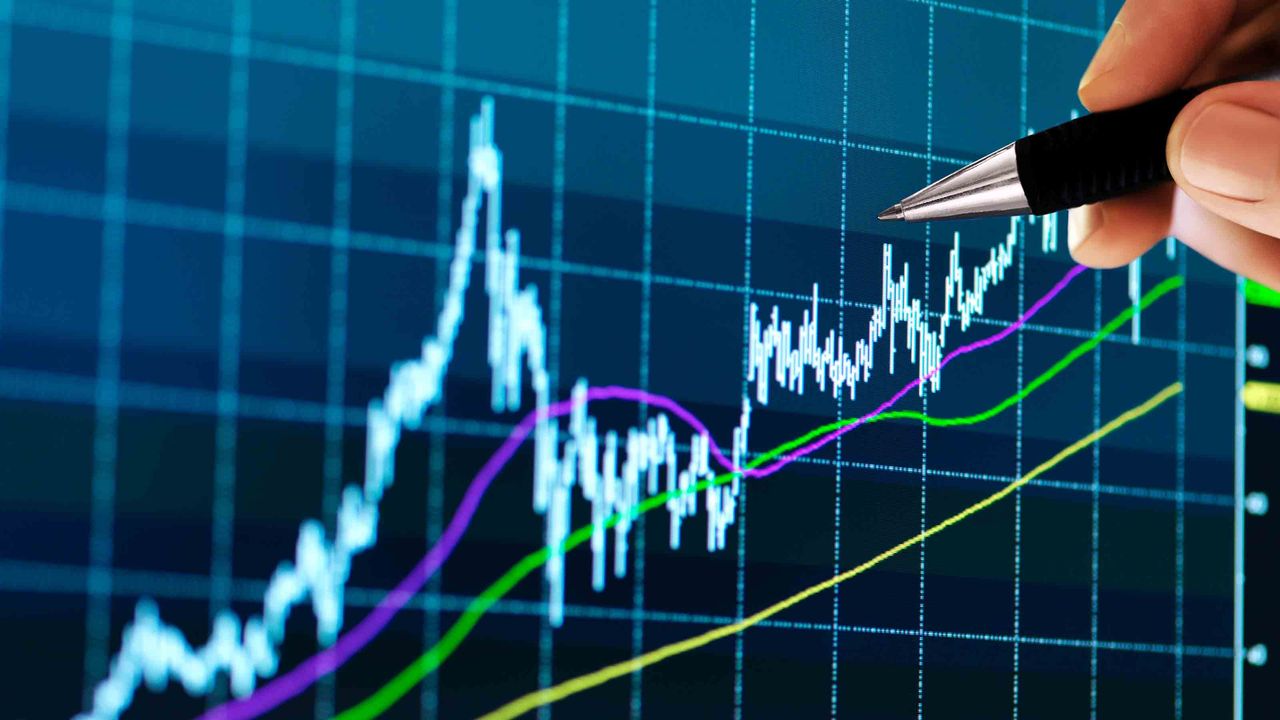 Technical analyst pointing at stock chart going up