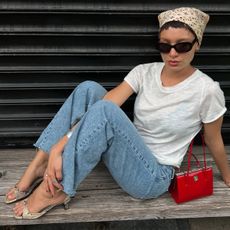 @aishafarida wearing a white T-shirt and jeans outfit with kitten heels