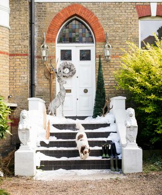 festive front porch with steps and reindeer ornament