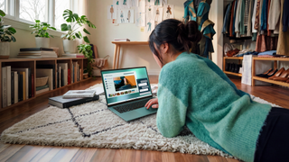 Dell XPS 14 being used by someone lying on the floor, they're using the trackpad