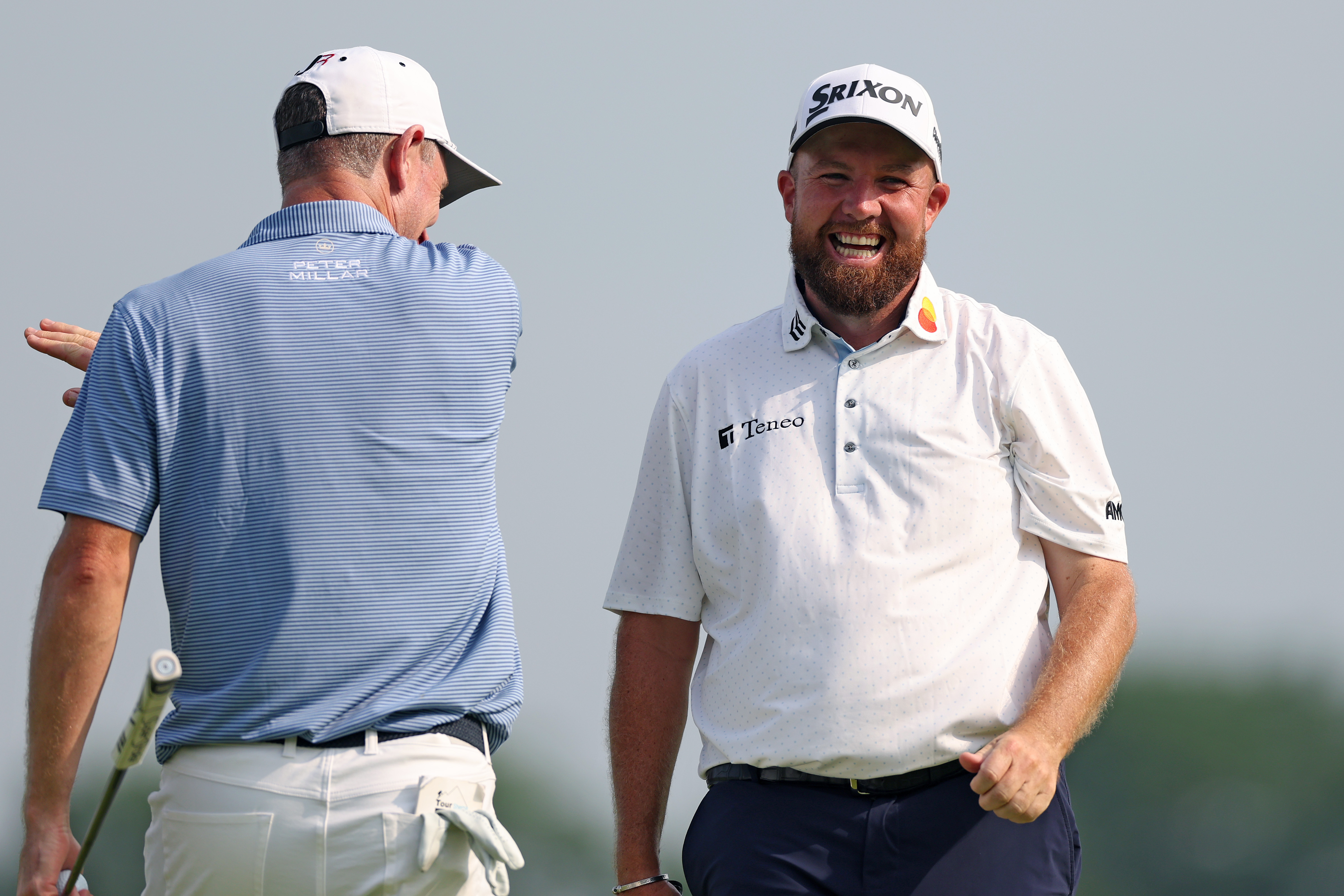 Shane Lowry walks off the green laughing
