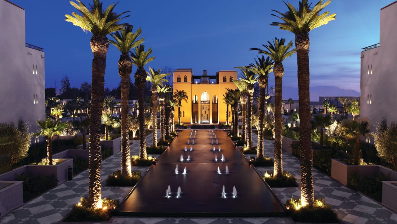 Outdoor avenue leading up to the front of Four Seasons Marrakech at night.