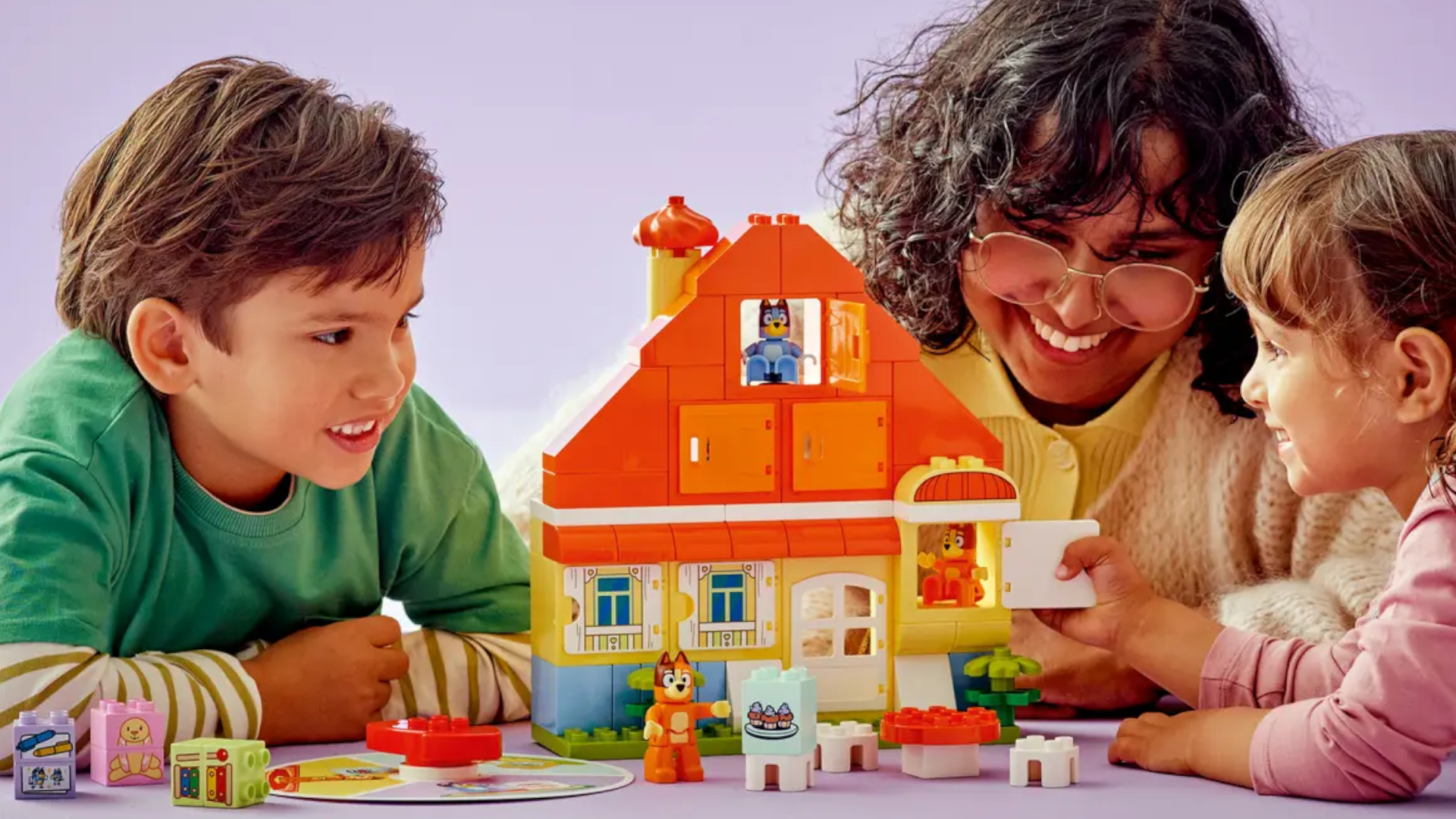 Duplo Bluey's Family House with Memory Game being played with by a woman and two children