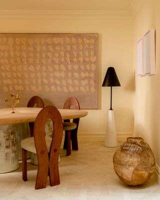 Dining room with magnolia walls, chunky wood table and curved wood chairs