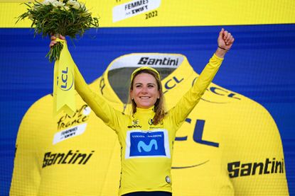 Annemiek van Vleuten on a podium in a yellow jersey