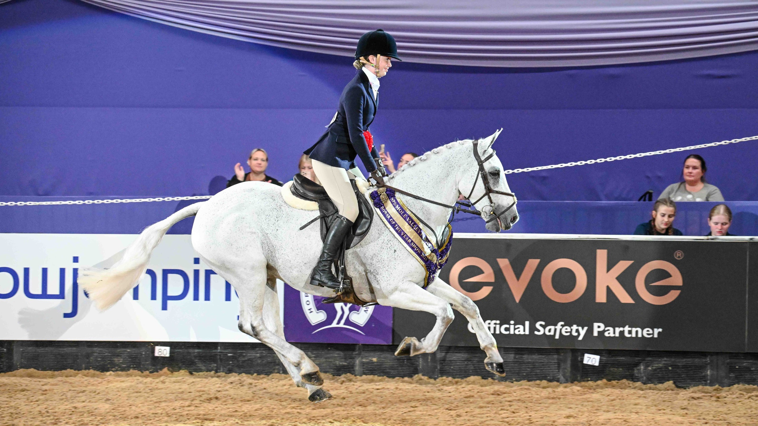 Star Smokey and Florence Duncalf gallop round the main arena at HOYS 2026 after winning the working hunter pony championship