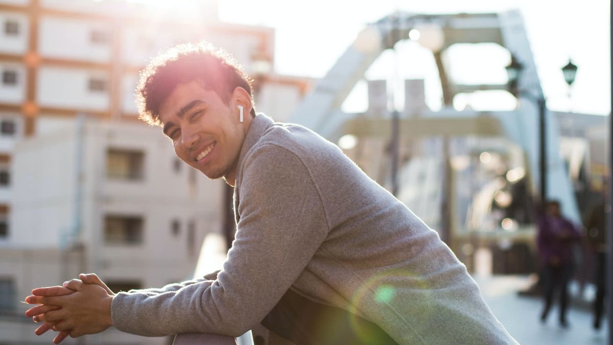 AirPods worn by a man, smiling