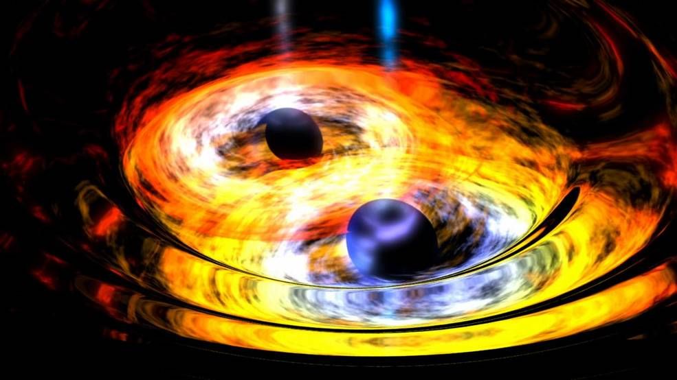 Two black holes surrounded by yellow rings spiral into each other