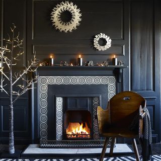 a living room with fireplace with gold and monochrome decor
