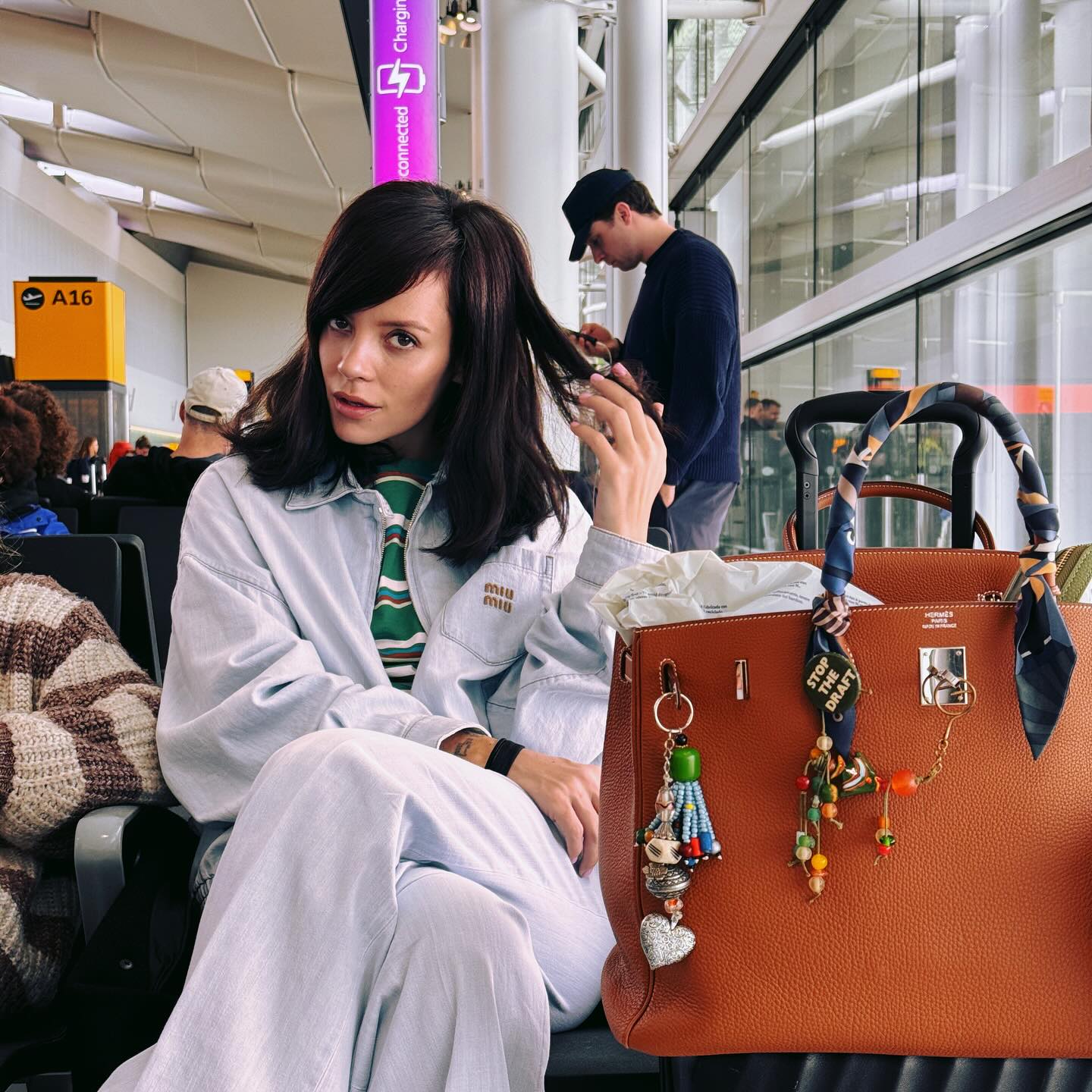 Lily Allen posed with a brown Hermes Birkin Bag that features lots of bag charms.