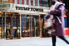 Pedestrians walk past Trump Tower