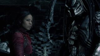 Screenshot from the movie Alien vs. Predator. A woman and a Predator stand together, having forged an alliance.