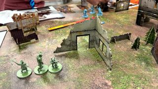 Models, terrain, tokens, and range rulers for Mutant Year Zero: Zone Wars set up on a battlemat