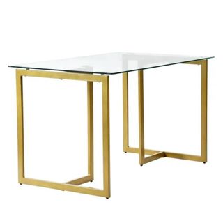 A glass dining table with gold legs