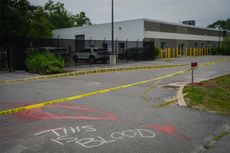 Red paint and the words "This Is Blood" written in chalk is seen on the pavement outside of a federal immigration office after a man was fatally shot by U.S. Immigration and Customs Enforcement (ICE) agents