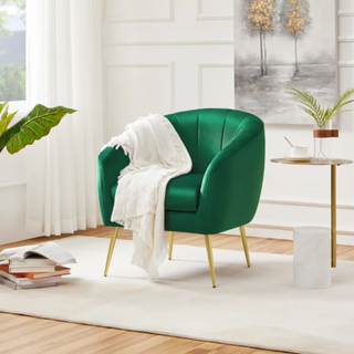 A green barrel chair in a living room.
