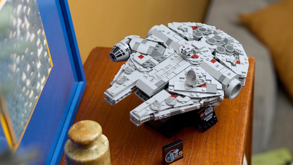 Lego Millennium Falcon on a shelf beside a picture in a blue frame