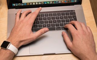 person with hands on laptop