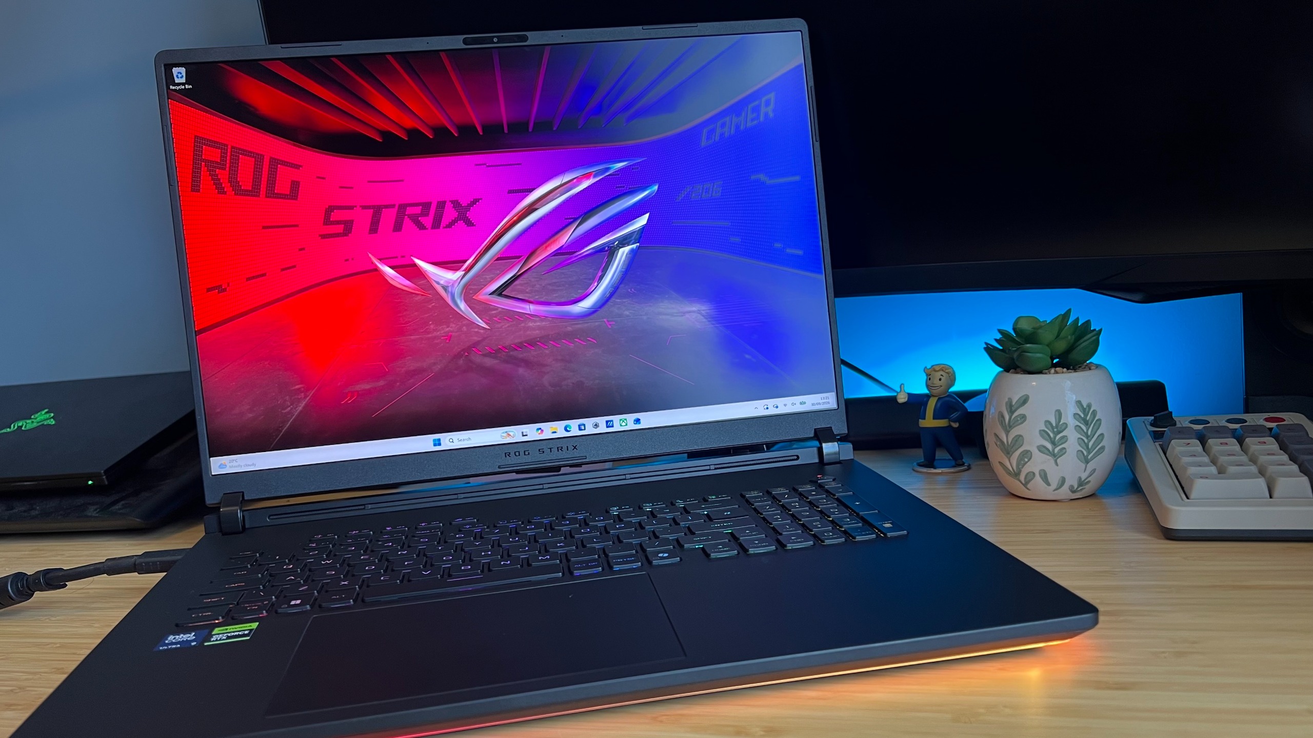 Asus ROG Strix Scar 18 gaming laptop on a wooden desk