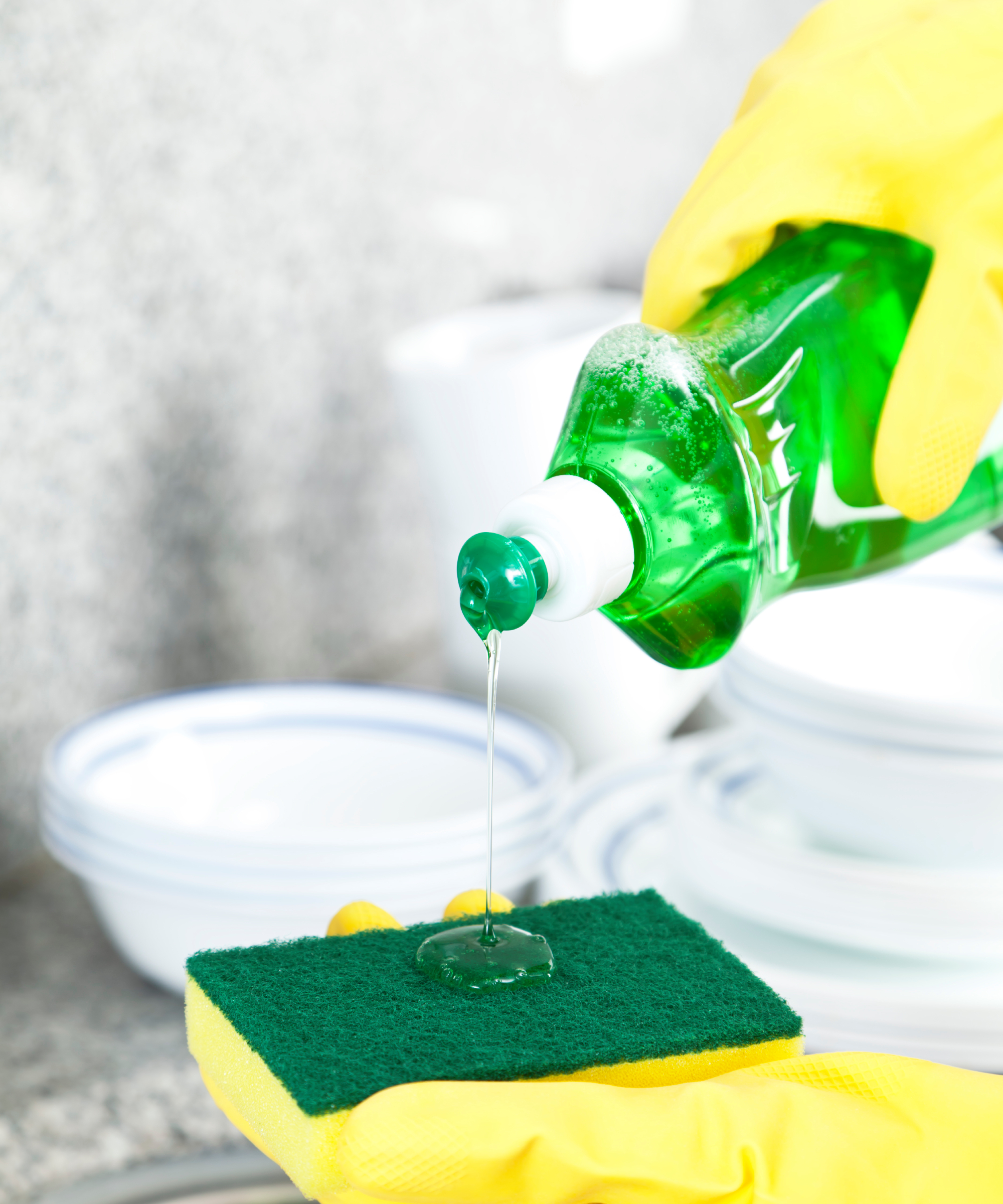 Pouring Dishwashing Detergent on Scrubbing Sponge