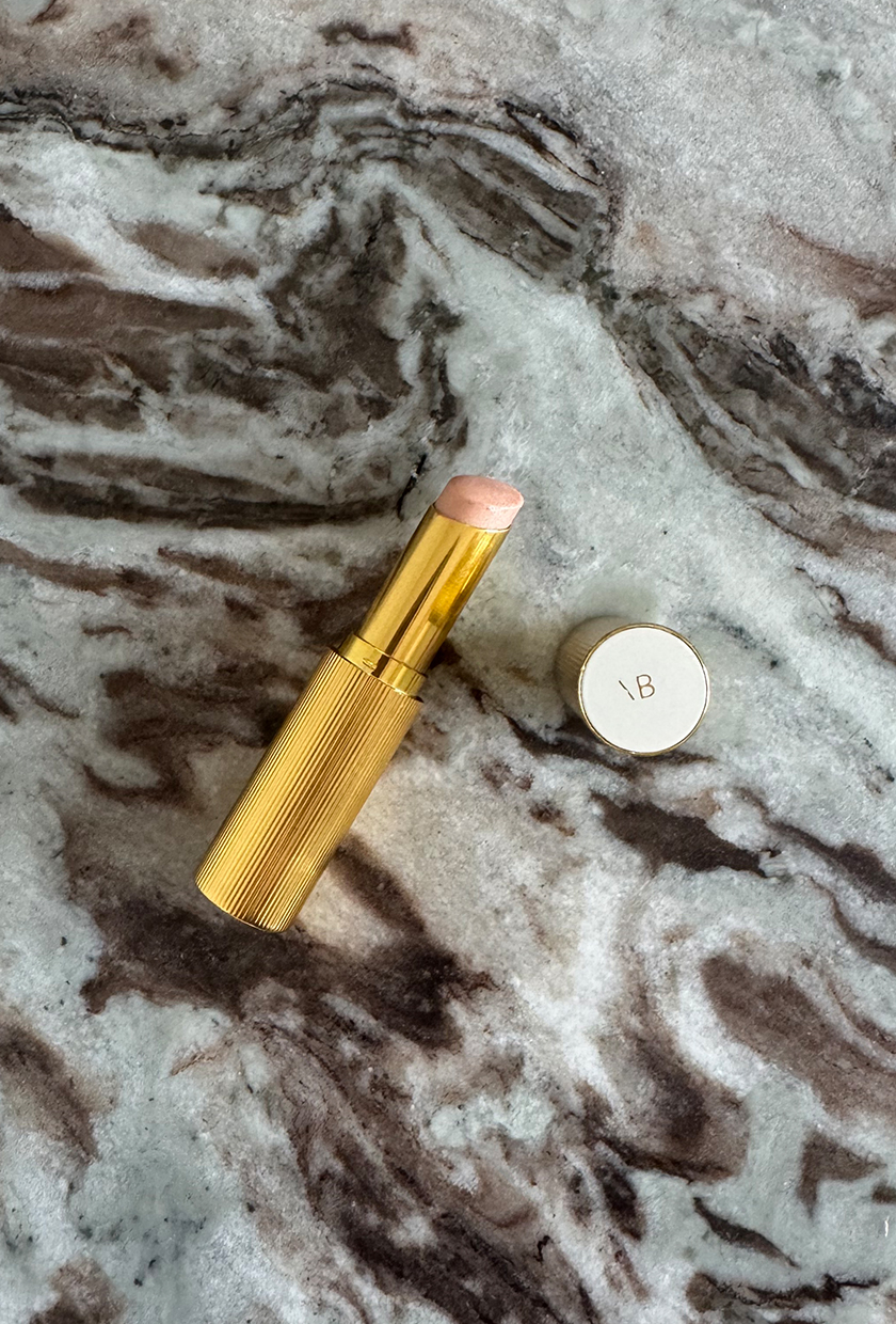 Victoria Beckham highlighter stick on marble background
