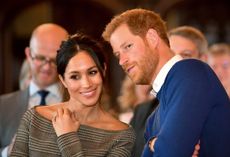 Prince Harry, Duke of Sussex, seen whispering something to Meghan, Duchess of Sussex.