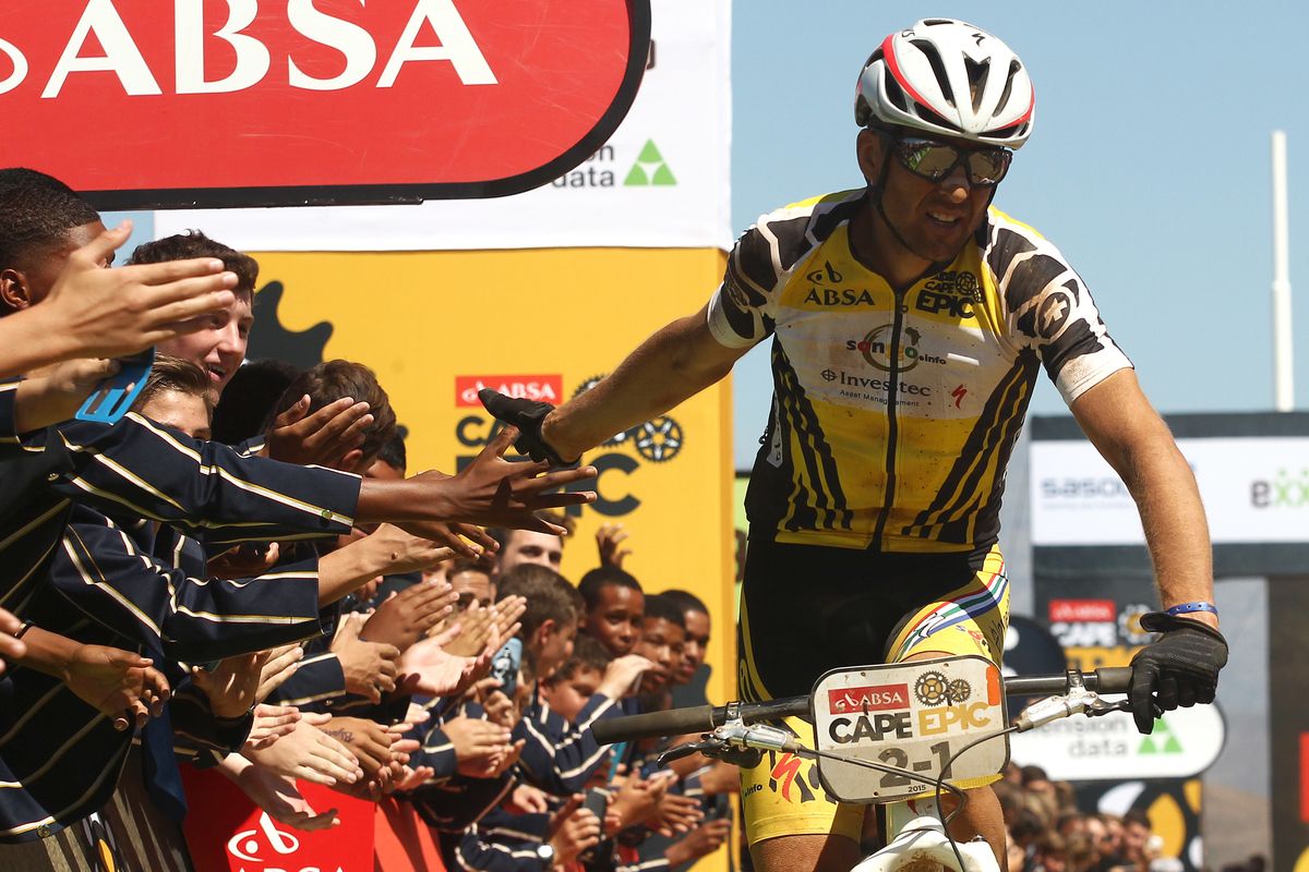 Christoph Sauser of Investec-Songo-Specialized celebrates with the HTS Drostdy school Learners after winning stage 3 with partner Jaroslav Kulhavy
