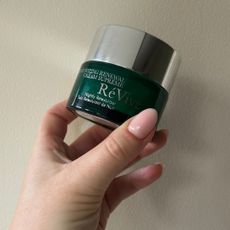 Tori holding RéVive Moisturizing Renewal Cream Supreme