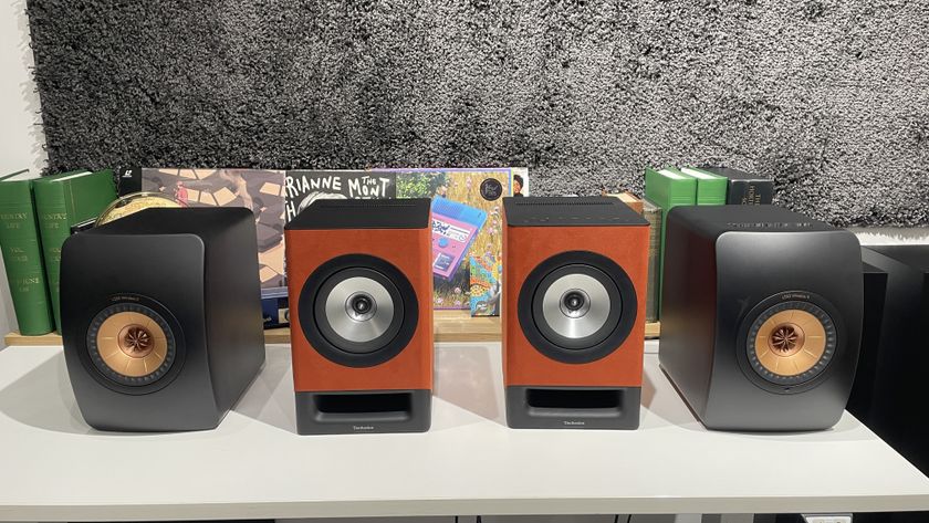 KEF LS50 Wireless II streaming speaker system on a desk next to the the Technics SC-CX700