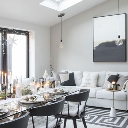 dining table with festive tablescape in open plan area with white sofa