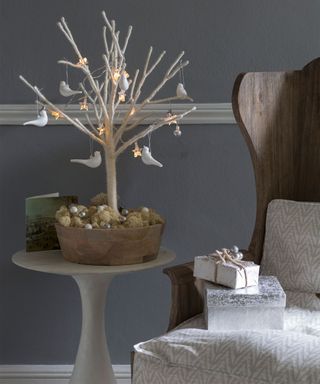 Small mini twig Christmas tree, gifts, presents, star fairy lights, wooden armchair