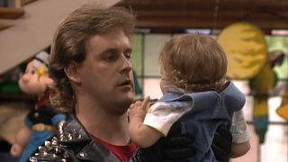 Screeshot of Joey holding Michelle on Full House.