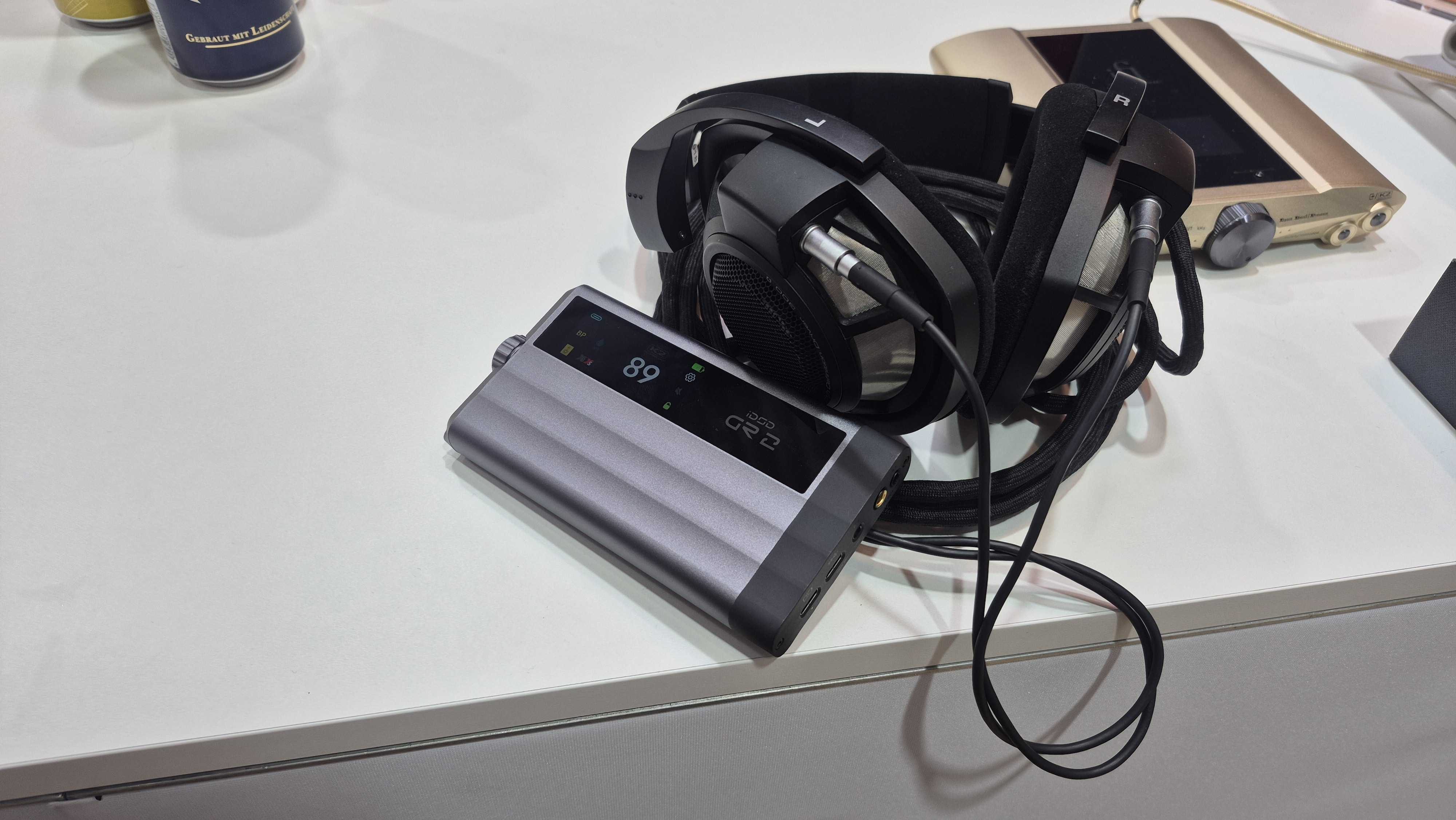 iFi iDSD GR 2 on table with some headphones
